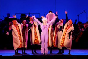 Beverly D’Angelo as “Simpsons” character Lurleen Lumpkin, backed by a chorus line of dancing Kwik-E-Mart hot dogs. Photo by Matthew Imaging