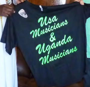 Before departing he presented a surprise gift to his new musician friends: custom-printed T-shirts printed bearing the phrase “USA Musicians & Uganda Musicians” — with a picture of his ngoma emblazoned at the top.