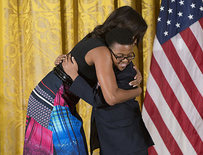 First Lady Michelle Obama hugs Project STEP student Ajani Boyd. Photo: Steve E. Purcell
